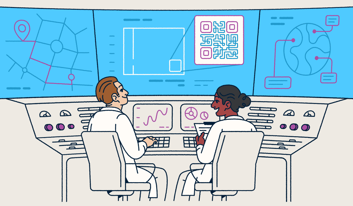 Two scientists sitting at a console looking at screens with QR Codes and graphs.