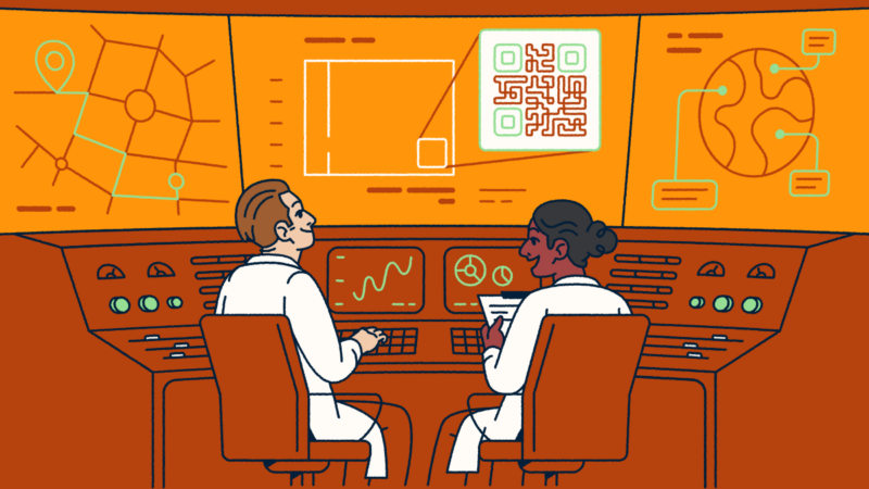 Two scientists sitting at a console looking at screens with QR Codes and graphs.