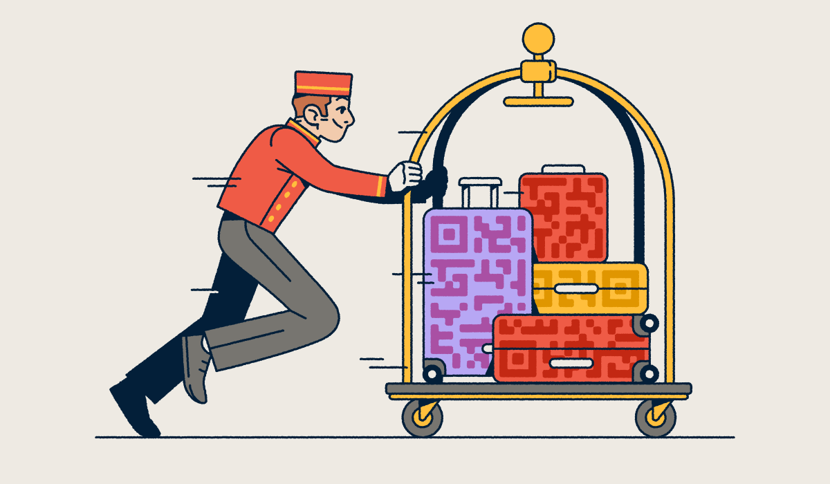 A bellhop pushing a luggage cart with several suitcases that have QR Code prints on them.