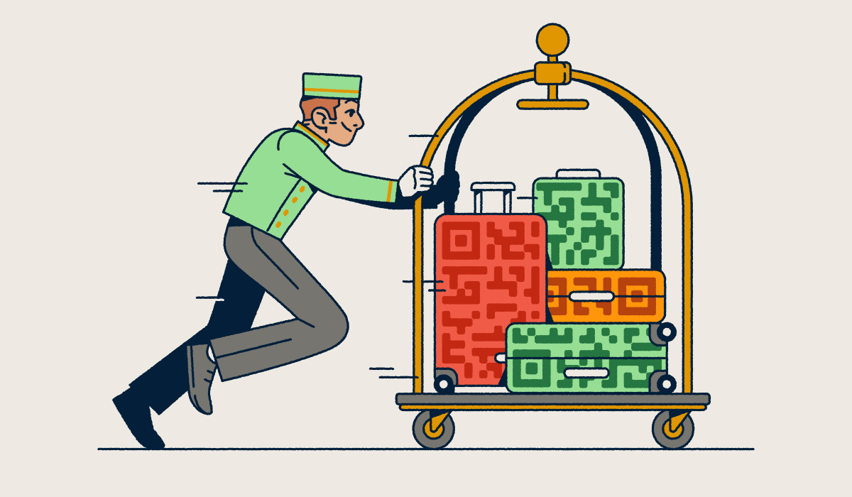 A bellhop pushing a luggage cart with several suitcases that have QR Code prints on them.
