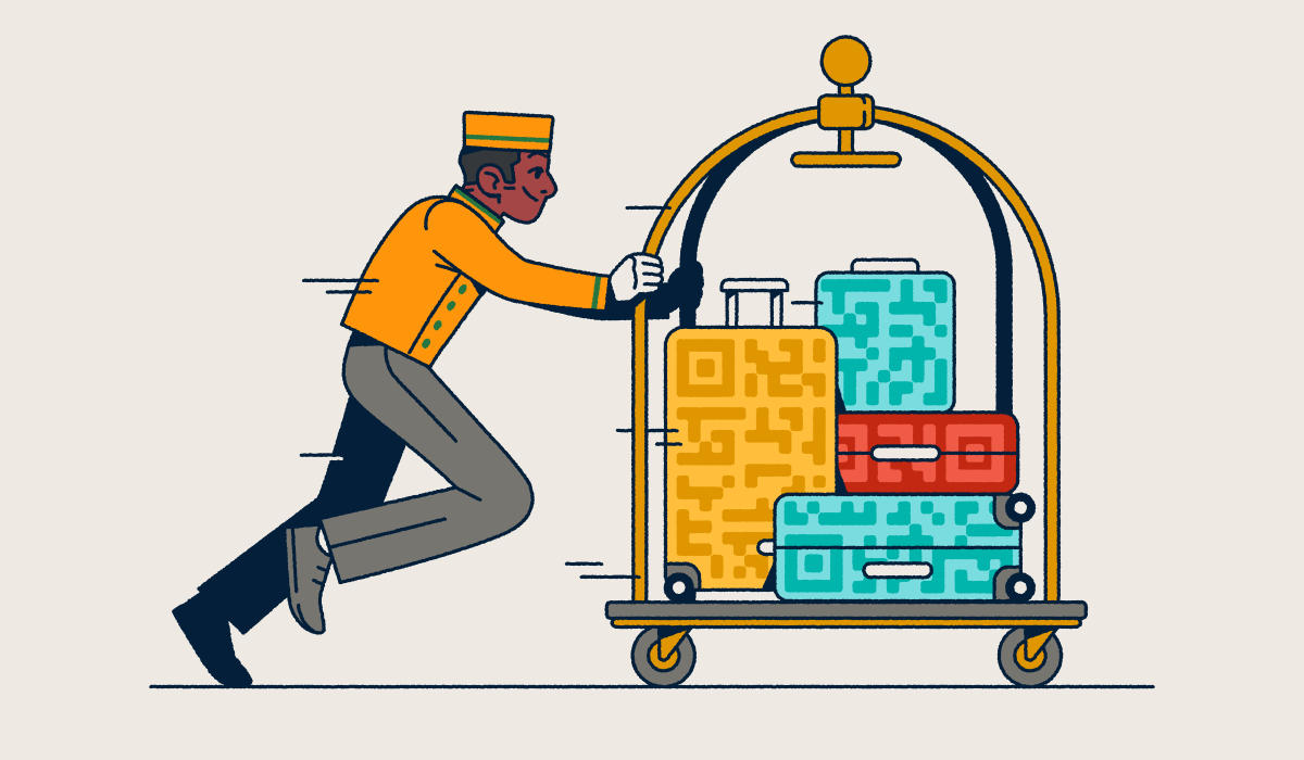 A bellhop pushing a luggage cart with several suitcases that have QR Code prints on them.