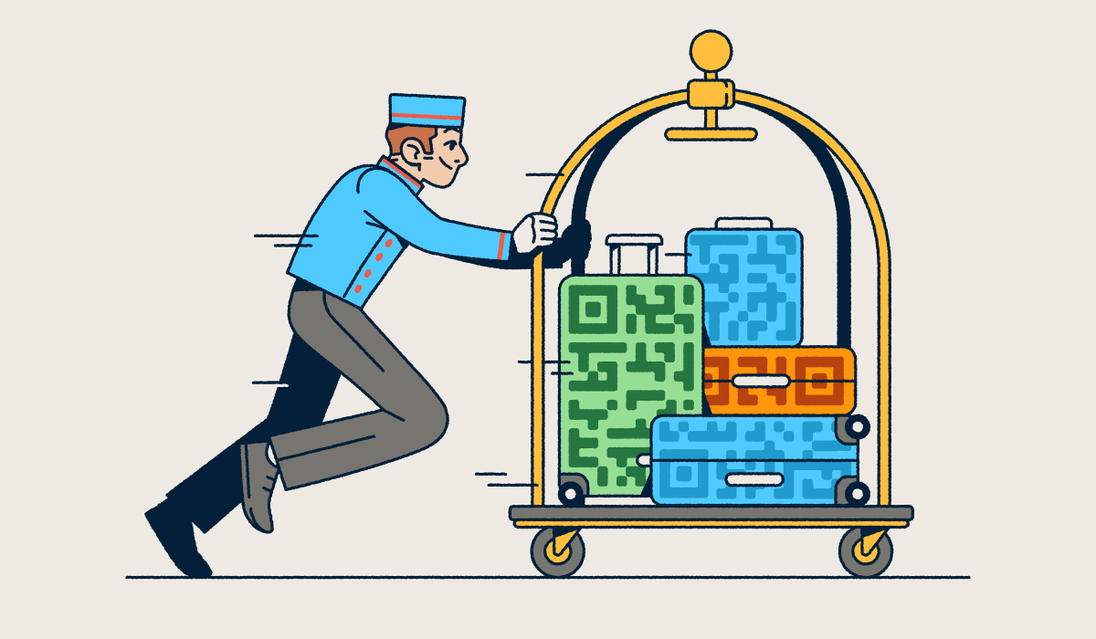 A bellhop pushing a luggage cart with several suitcases that have QR Code prints on them.