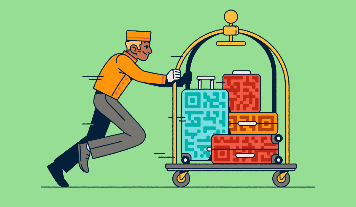 A bellhop pushing a luggage cart with several suitcases that have QR Code prints on them.