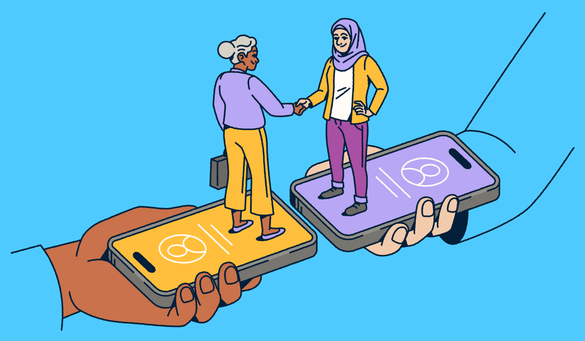 Two people standing on smartphones shaking hands.