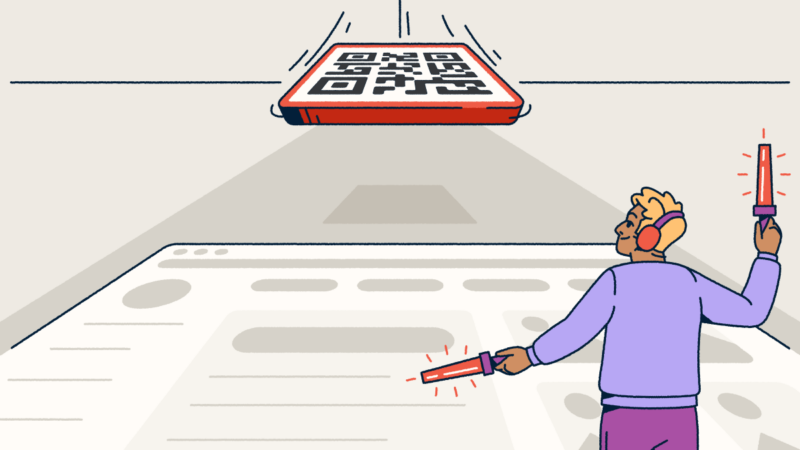 A person waving airport marshalling wands on a landing strip. They are guiding a QR Code to land.