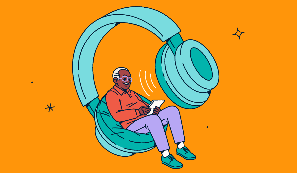 A person looking at a tablet while sitting in one side of a giant pair of headphones.