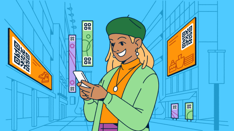 A woman standing in a city with digital advertisements featuring QR Codes around her. She's holding a smartphone in her hands.