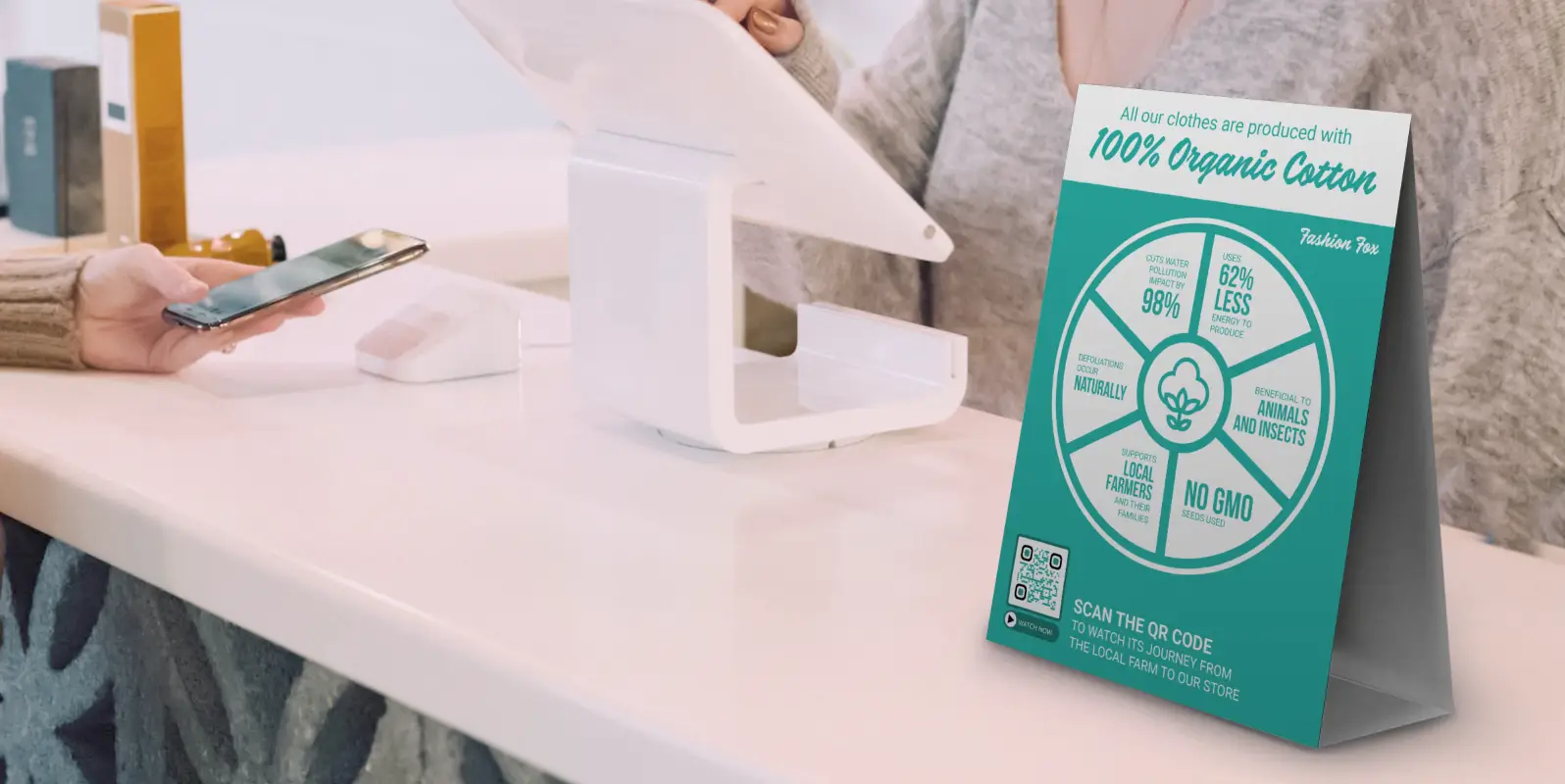 A table talker at a point of sale desk describing the origins of cotton. A QR Code at the bottom features a video for more information.