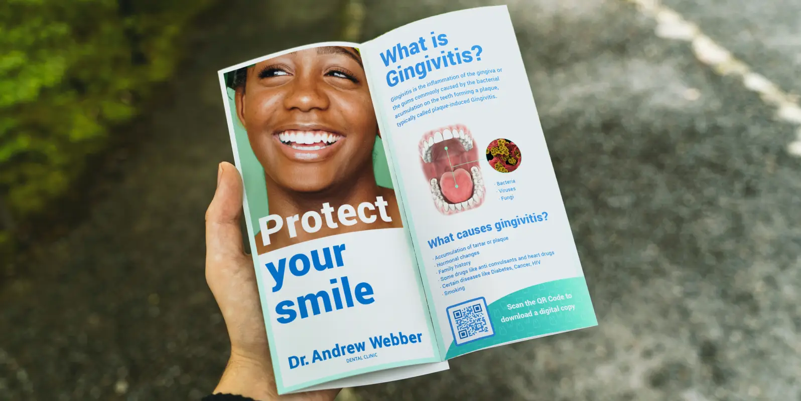 A hand holding a dentist's brochure about protecting your smile. There's a QR Code in the bottom-left corner to download a digital copy.