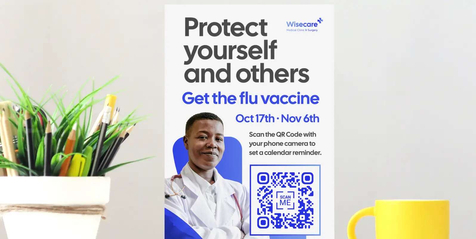 A flower pot with pens and pencils next to a clinic's tabletop sign promoting a flu vaccination. There's a QR Code on the sign for setting a calendar reminder.