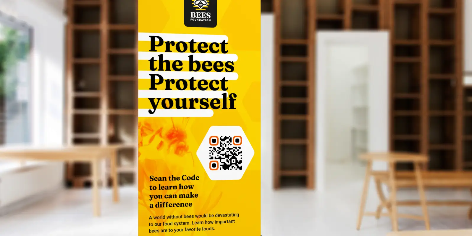 A standing poster encourages readers to scan a QR Code to learn more about how they can help save the bees.