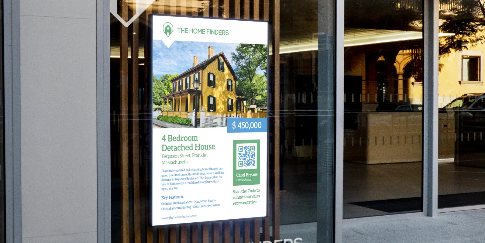 An advertisement for a detached house in the window of a real estate company. It features a QR Code to get into contact with the sales representative.