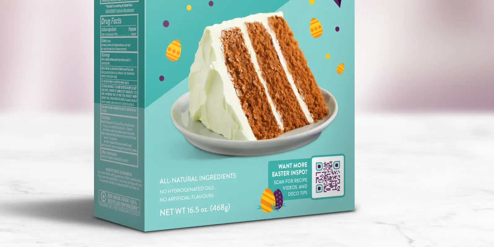 Closeup of a turquoise cake mix box featuring a plate with a large slice of cake on it and a QR Code for deco tip.