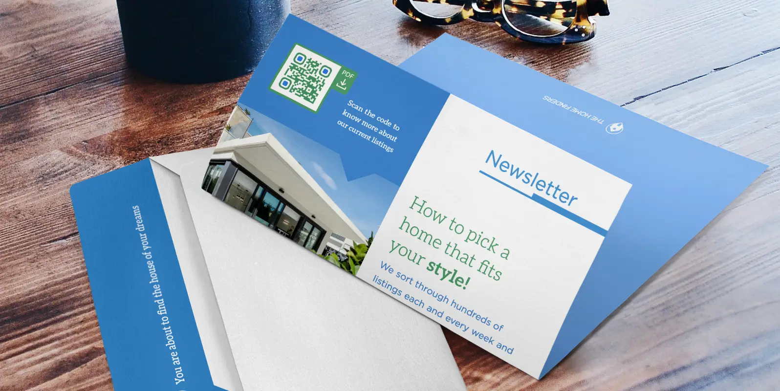 A real estate newsletter laying on a table. It features a QR Code with more information on listings.