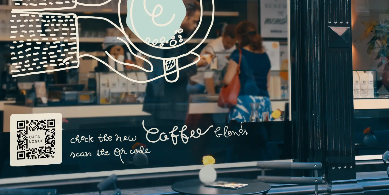 Cafe window display with hands around a coffee and a QR Code underneath.